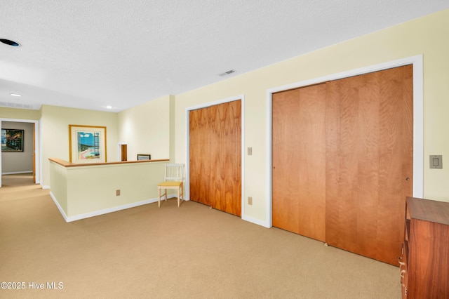 spare room with carpet floors, baseboards, a textured ceiling, and recessed lighting
