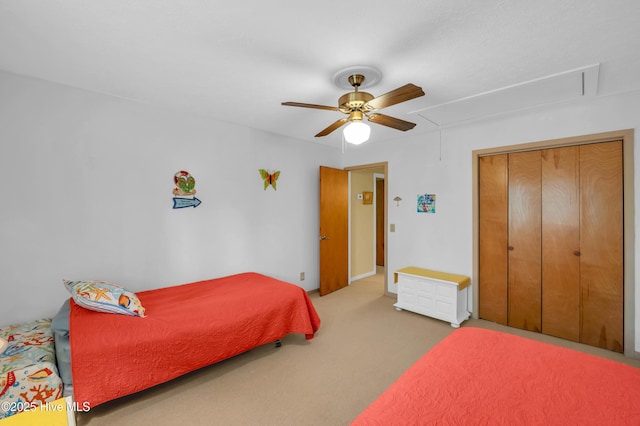 bedroom featuring attic access, carpet floors, and a ceiling fan