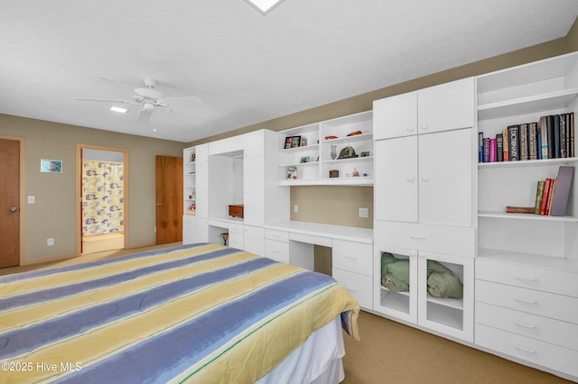 bedroom with light colored carpet and a ceiling fan