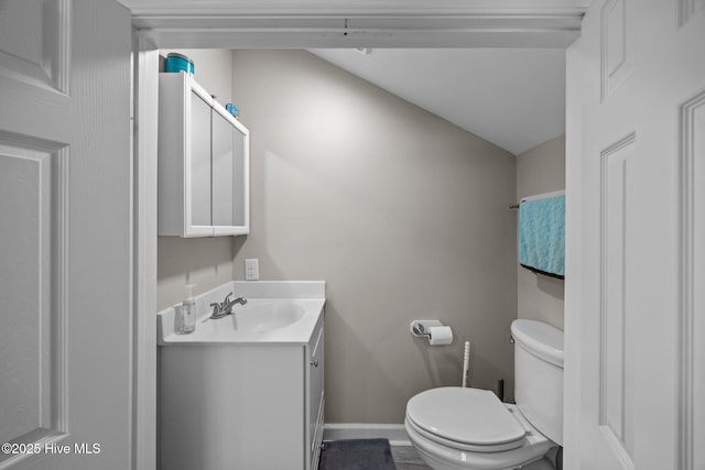 306 Channel Run Dr, New Bern, NC 28562 - half bathroom featuring vanity, toilet, baseboards, and lofted ceiling
