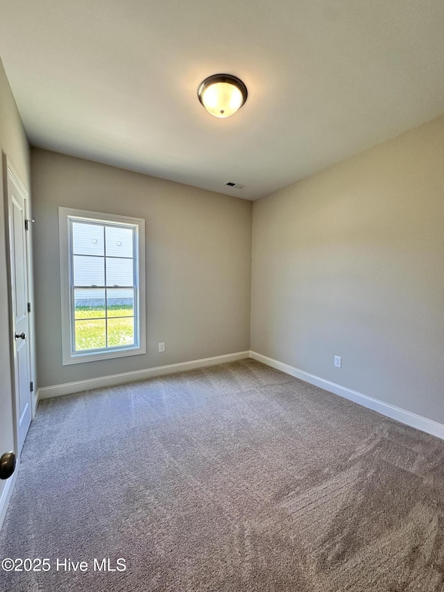 spare room with carpet floors and baseboards