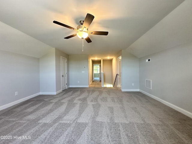 additional living space featuring a ceiling fan, baseboards, and carpet