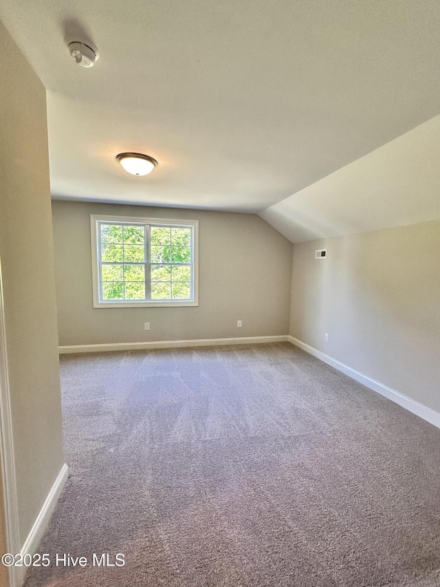 bonus room featuring baseboards, carpet, and lofted ceiling