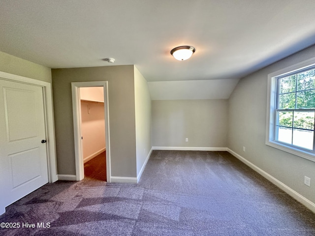 bonus room featuring carpet, vaulted ceiling, and baseboards