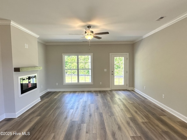unfurnished living room with ceiling fan, a glass covered fireplace, dark wood-style flooring, baseboards, and crown molding