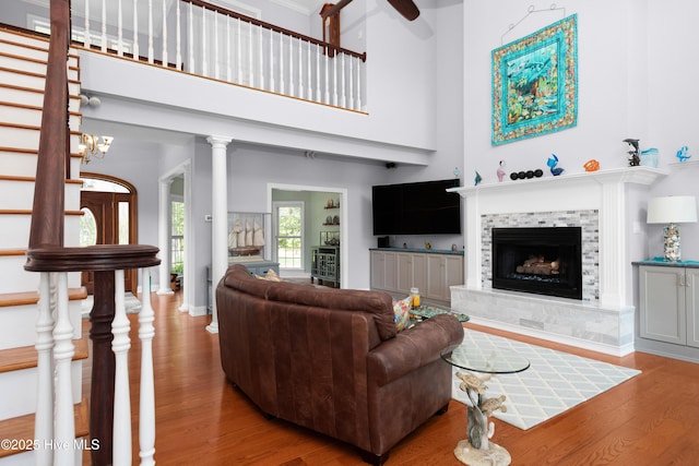 555 Dawson Creek Dr, Arapahoe, NC 28510 - living area with wood finished floors, a tile fireplace, baseboards, and a high ceiling
