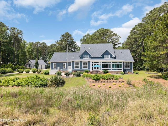 555 Dawson Creek Dr, Arapahoe, NC 28510 - rear view of house featuring roof with shingles and a yard