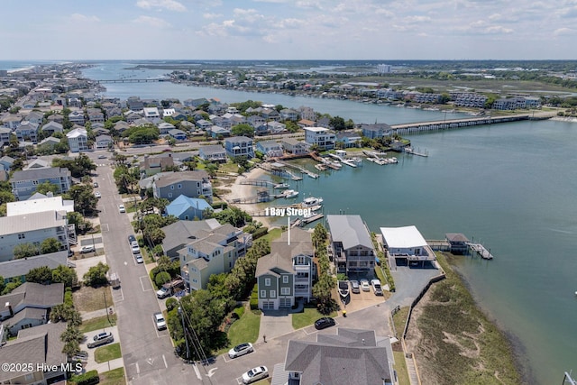 aerial view of residential area featuring a large body of water