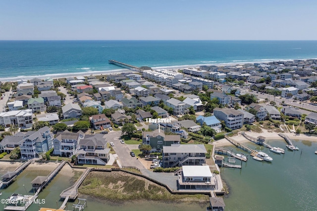aerial view of residential area featuring a large body of water