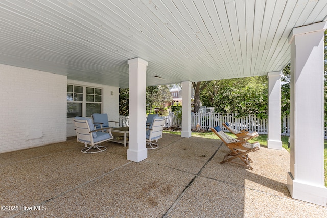 view of patio featuring fence and outdoor dining area