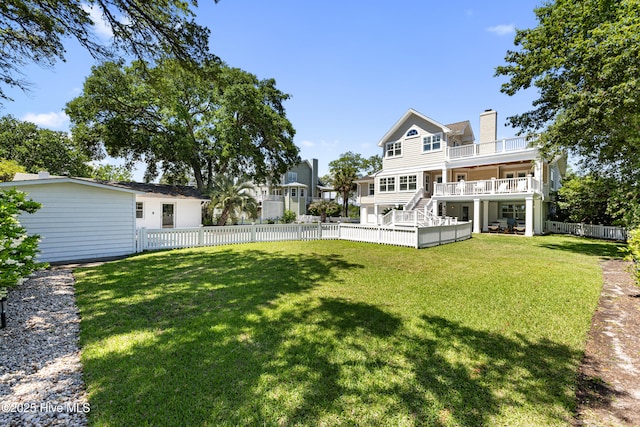 back of property with stairs, a chimney, and a deck