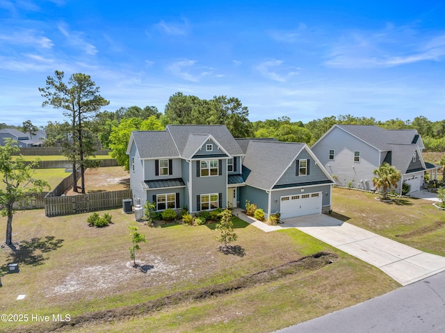 traditional-style home with a standing seam roof, concrete driveway, a garage, metal roof, and cooling unit