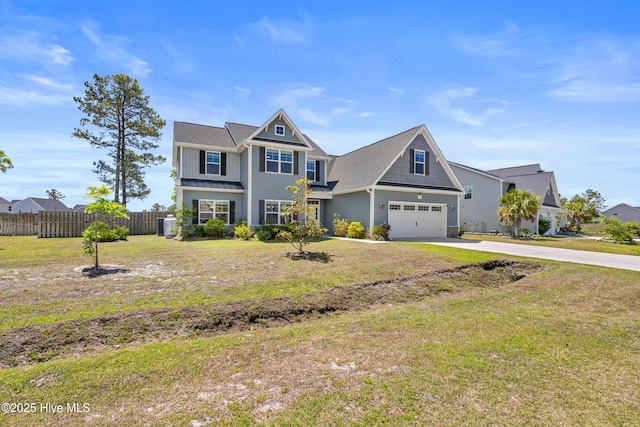 view of front of house with board and batten siding, driveway, a garage, and a standing seam roof