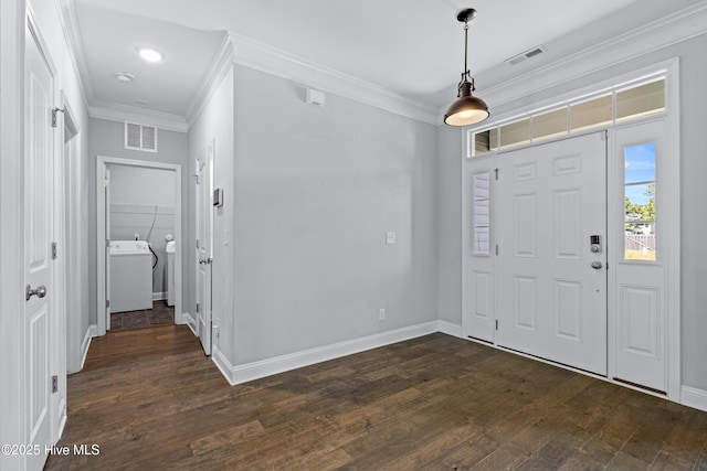 foyer entrance with washer / dryer, ornamental molding, dark wood-style flooring, and baseboards