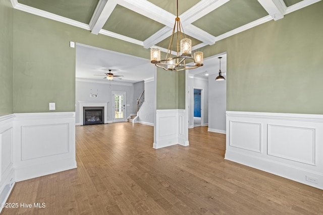 unfurnished dining area with coffered ceiling, a ceiling fan, a chandelier, beamed ceiling, and ornamental molding
