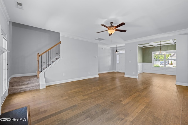 unfurnished living room featuring a chandelier, a ceiling fan, wood finished floors, crown molding, and stairway