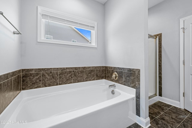 full bath with a shower stall, a bath, and tile patterned flooring