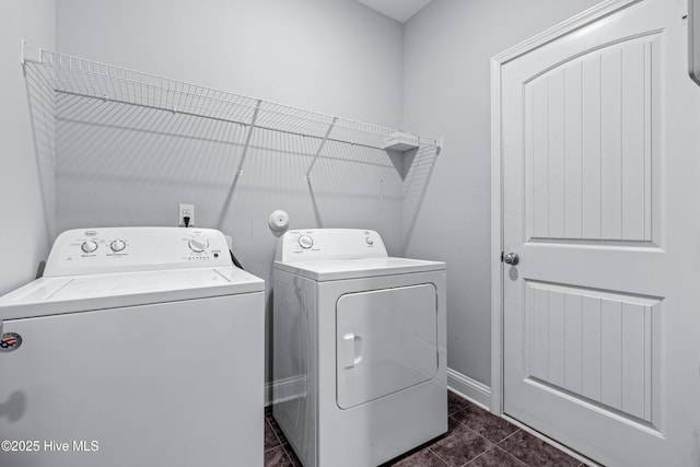 washroom with separate washer and dryer and baseboards