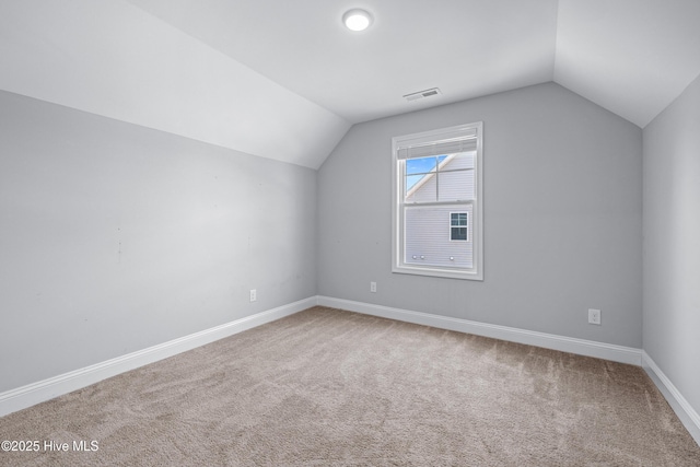 bonus room featuring vaulted ceiling, carpet floors, and baseboards