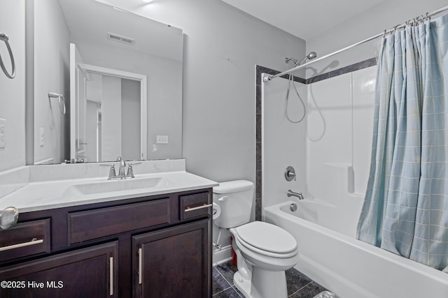 bathroom featuring toilet, vanity, shower / bath combo with shower curtain, and tile patterned flooring