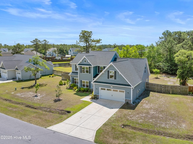 view of front of house featuring driveway, an attached garage, stone siding, and a residential view