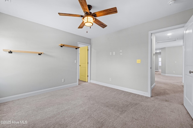 unfurnished bedroom featuring carpet, baseboards, and a ceiling fan