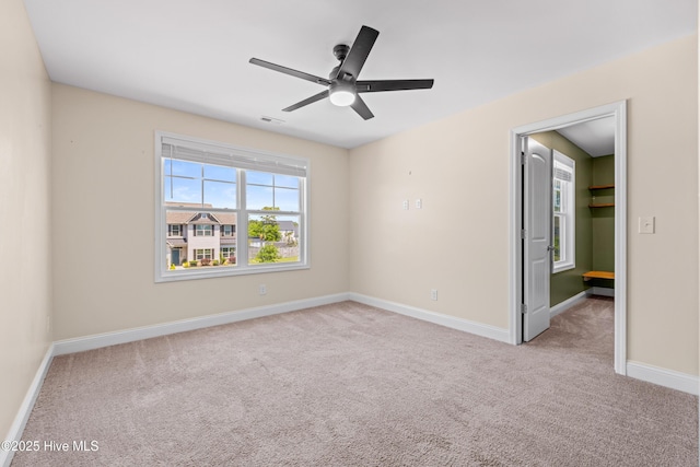 unfurnished bedroom featuring carpet floors, baseboards, and a ceiling fan