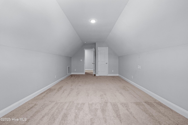 bonus room with vaulted ceiling, carpet flooring, and baseboards
