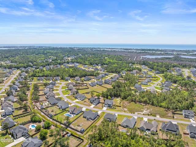 aerial overview of property's location featuring nearby suburban area and a large body of water