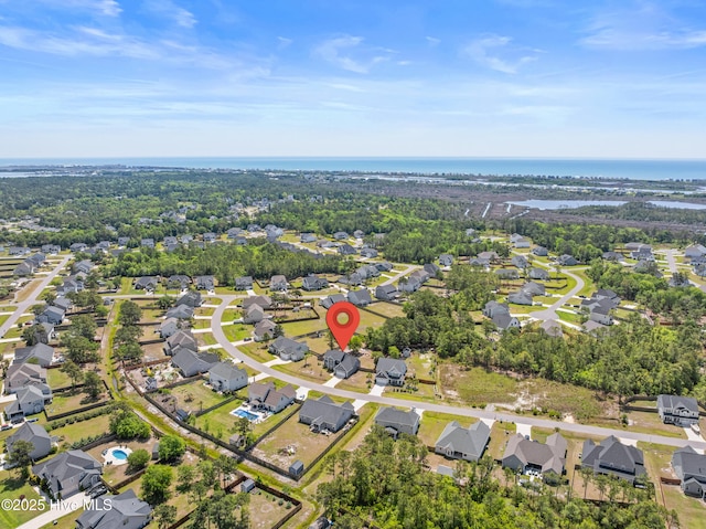 aerial view of property and surrounding area with nearby suburban area and a nearby body of water