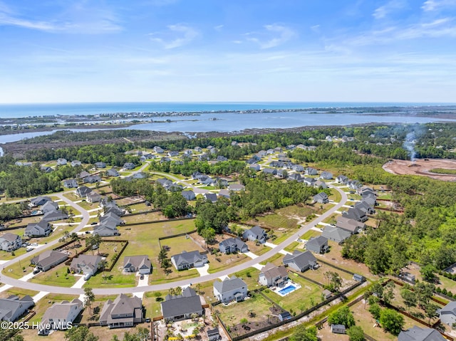 aerial overview of property's location featuring a large body of water and nearby suburban area
