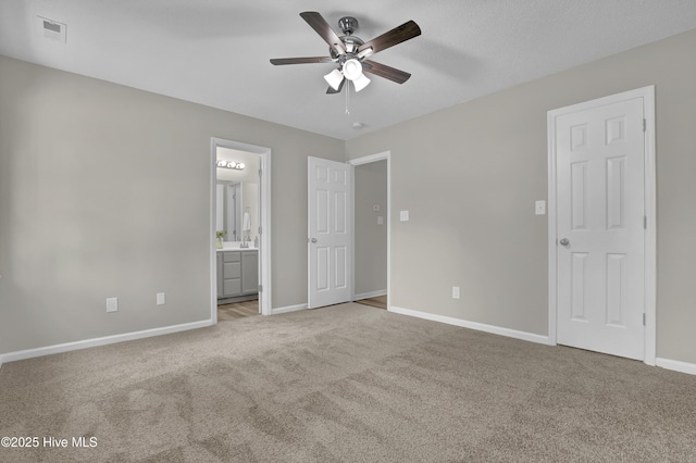 117 Clint Mills Rd, Maysville, NC 28555 - unfurnished bedroom featuring carpet flooring, baseboards, ensuite bathroom, and a ceiling fan