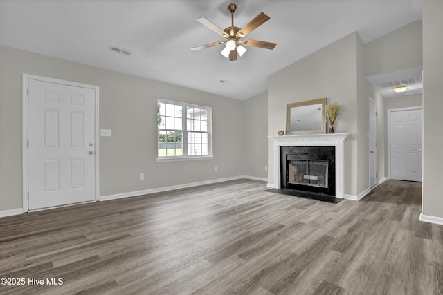 117 Clint Mills Rd, Maysville, NC 28555 - unfurnished living room featuring lofted ceiling, a ceiling fan, wood finished floors, a fireplace with flush hearth, and baseboards