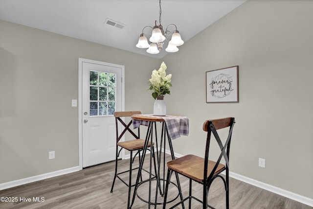 117 Clint Mills Rd, Maysville, NC 28555 - dining room featuring wood finished floors, a chandelier, and baseboards