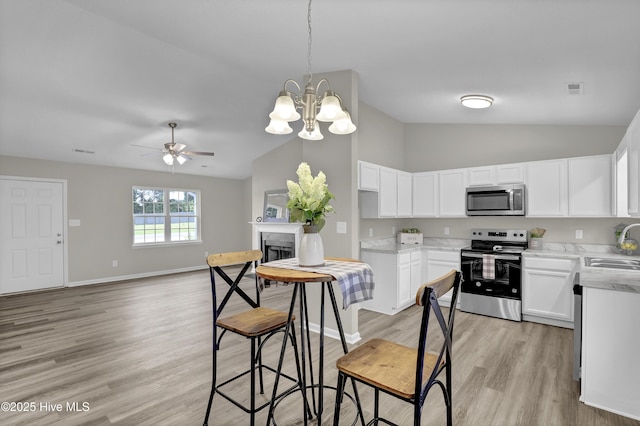117 Clint Mills Rd, Maysville, NC 28555 - kitchen featuring appliances with stainless steel finishes, vaulted ceiling, ceiling fan, a sink, and light wood finished floors