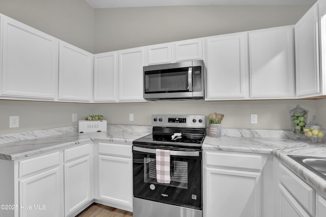 117 Clint Mills Rd, Maysville, NC 28555 - kitchen with stainless steel appliances, white cabinetry, and light stone counters
