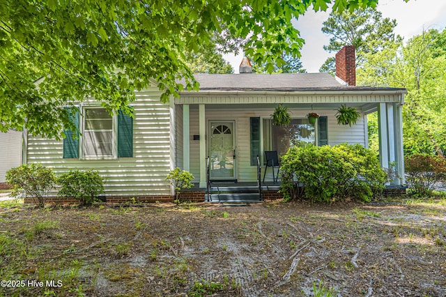 513 Atkinson St, Laurinburg, NC 28352 - bungalow-style house with covered porch and a chimney
