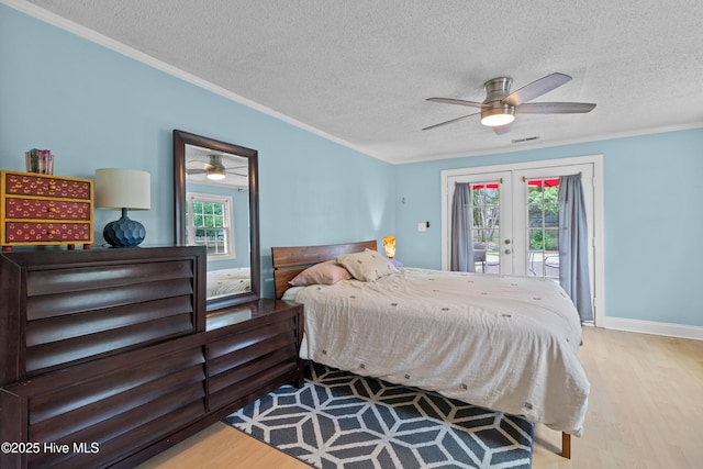 bedroom with french doors, ornamental molding, wood finished floors, access to outside, and a textured ceiling