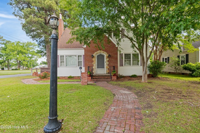1306 W Church St, Elizabeth City, NC 27909 - view of front of home with a front yard, a chimney, and roof with shingles