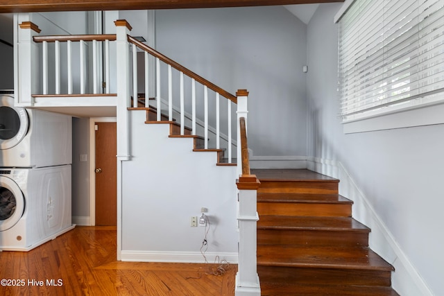 1306 W Church St, Elizabeth City, NC 27909 - staircase with stacked washer and clothes dryer, baseboards, and wood finished floors