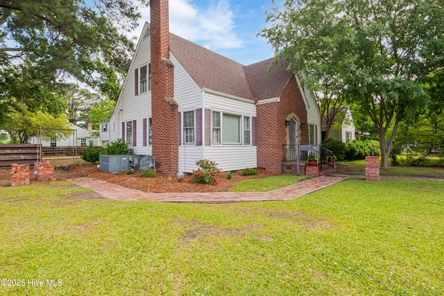 1306 W Church St, Elizabeth City, NC 27909 - view of side of property featuring a shingled roof and a chimney