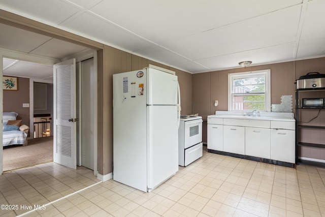 1306 W Church St, Elizabeth City, NC 27909 - kitchen featuring white appliances, light countertops, white cabinetry, and a sink
