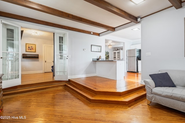 1306 W Church St, Elizabeth City, NC 27909 - living area featuring baseboards, beamed ceiling, and light wood-style floors