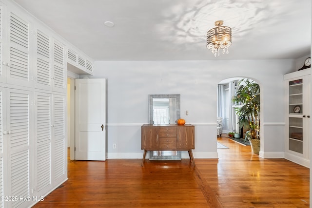 1306 W Church St, Elizabeth City, NC 27909 - dining area featuring wood finished floors, arched walkways, a chandelier, and baseboards