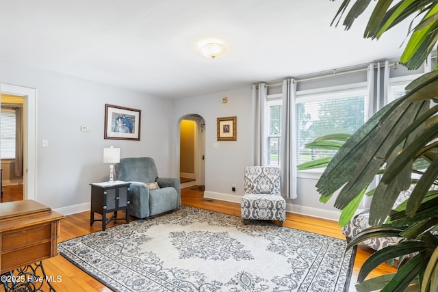 1306 W Church St, Elizabeth City, NC 27909 - living area featuring arched walkways, wood finished floors, and baseboards