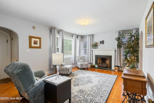 1306 W Church St, Elizabeth City, NC 27909 - living area featuring arched walkways, wood finished floors, and a fireplace with raised hearth