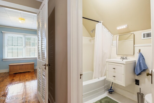 1306 W Church St, Elizabeth City, NC 27909 - full bathroom with shower / bath combo, vanity, and wood finished floors