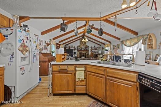 117 Arthur Rd, Beaufort, NC 28516 - kitchen featuring dishwasher, white fridge with ice dispenser, a sink, light wood finished floors, and a textured ceiling