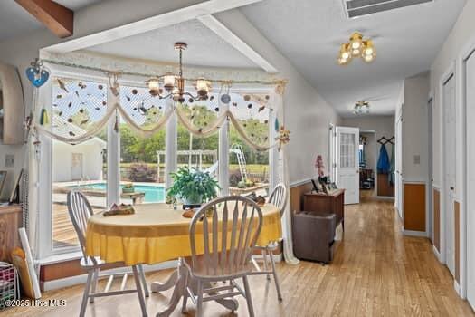 117 Arthur Rd, Beaufort, NC 28516 - dining room with a chandelier and light wood-style flooring