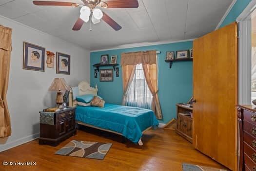 117 Arthur Rd, Beaufort, NC 28516 - bedroom with wood finished floors, baseboards, a ceiling fan, and crown molding